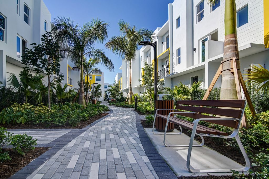 street view of jogging path with bench and tropical garden landscaping