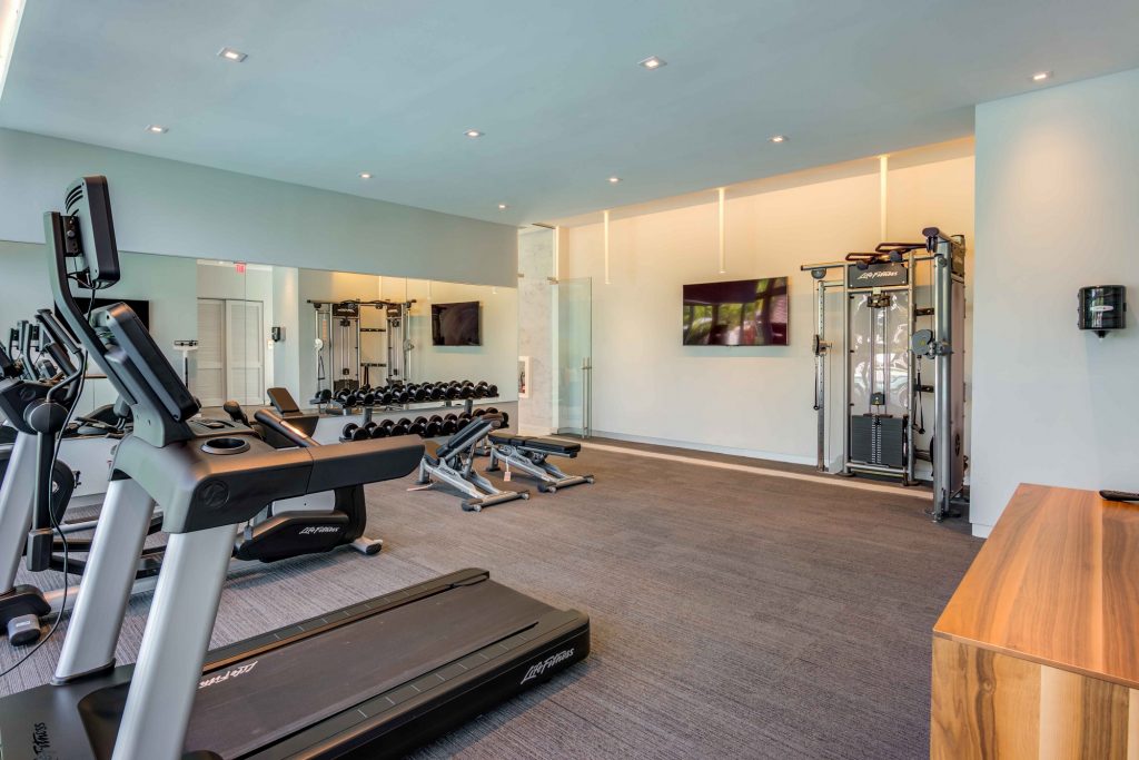 Indoor gym area with workout machines and cardio machines